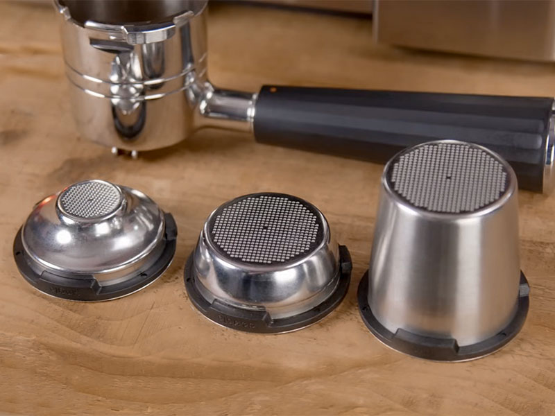 The single, double, and luxe filter baskets laid out in front of portafilter for the Ninja Luxe Cafe Pro