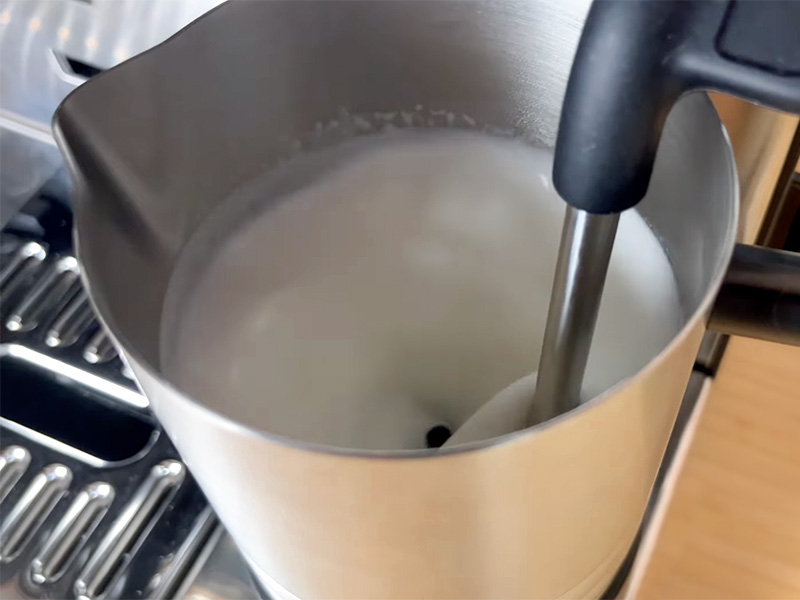 Top-down view into the milk jug whilst the Ninja Luxe Cafe Pro's Dual Froth System Pro steams and whisks the milk at the same time