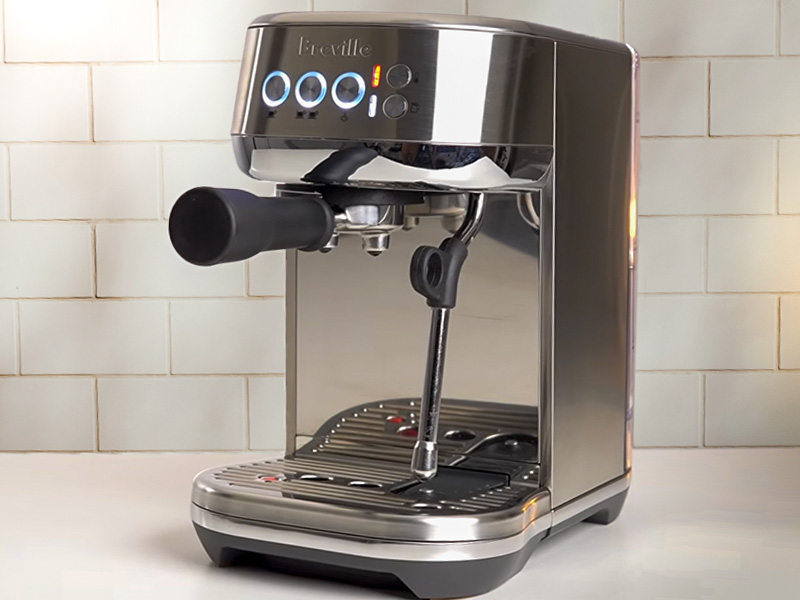 Breville Bambino Plus slightly turned to the side, sitting on kitchen counter