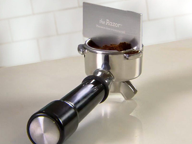 Close-up of the Razor tool from Breville sitting in a portafilter with freshly ground coffee