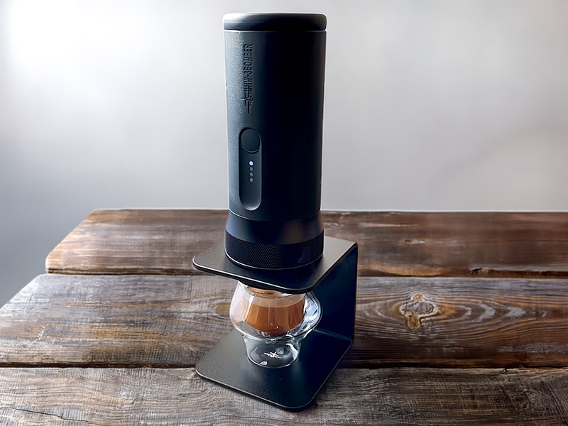 MHW-3BOMBER Xpress 58 on its included stand, with a fresh shot of espresso underneath