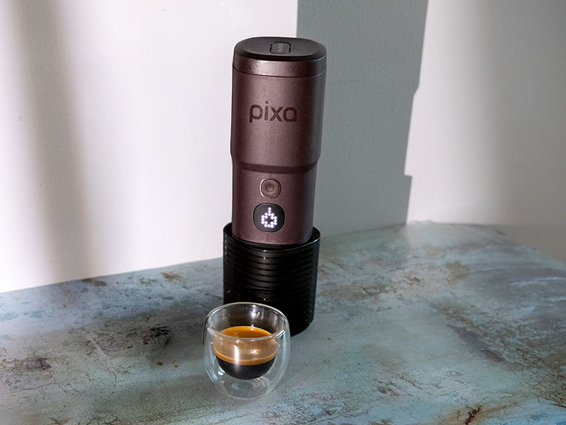 Fresh shot of espresso in a glass, sitting in front of the Wacaco Pixapresso