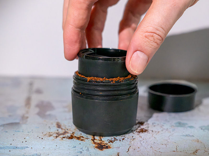 Tamping ground coffee for the Wacaco Pixapresso