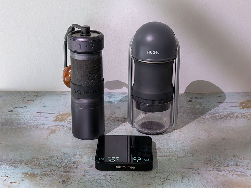 1Zpresso J Ultra, HUGH Leverpresso Lite, and MiiCoffee scale laid out on table
