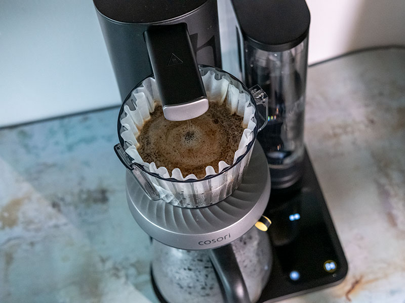 Top-down view of the filter basket during bloom phase of brewing pour over coffee on the Cosori Juni
